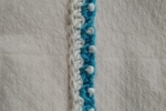 Braccialetto all'uncinetto realizzato con filo di cotone bianco e azzurro