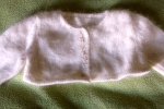 Coprispalla in lana con roselline